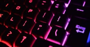 Vibrant close-up of a modern RGB backlit mechanical keyboard with glowing keys.