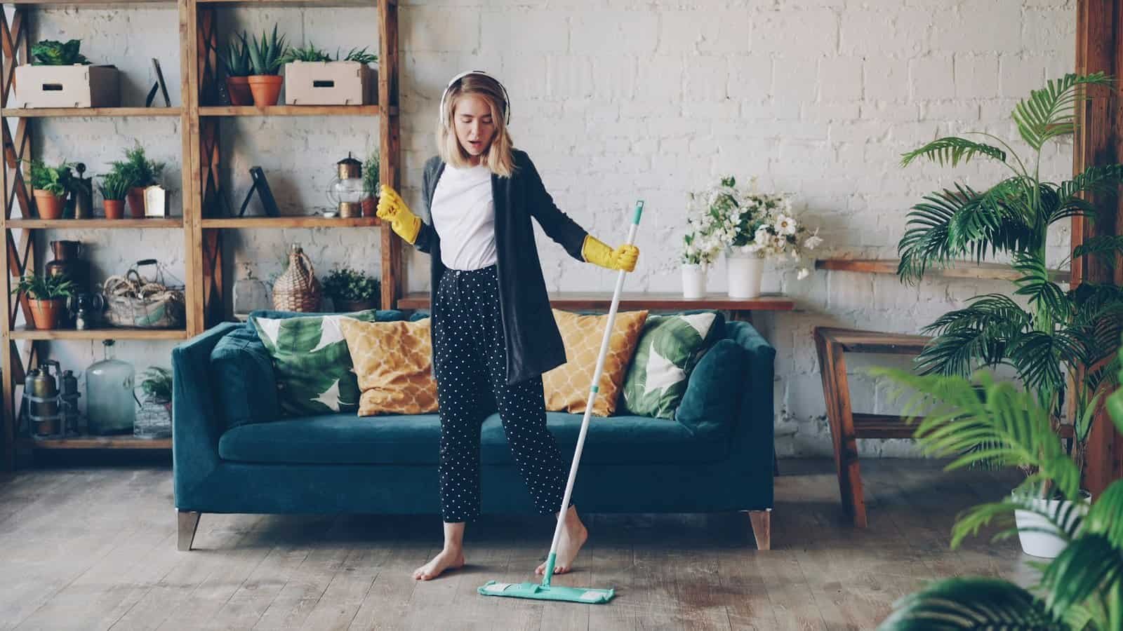 Woman cleaning with eco-friendly mop in living room.