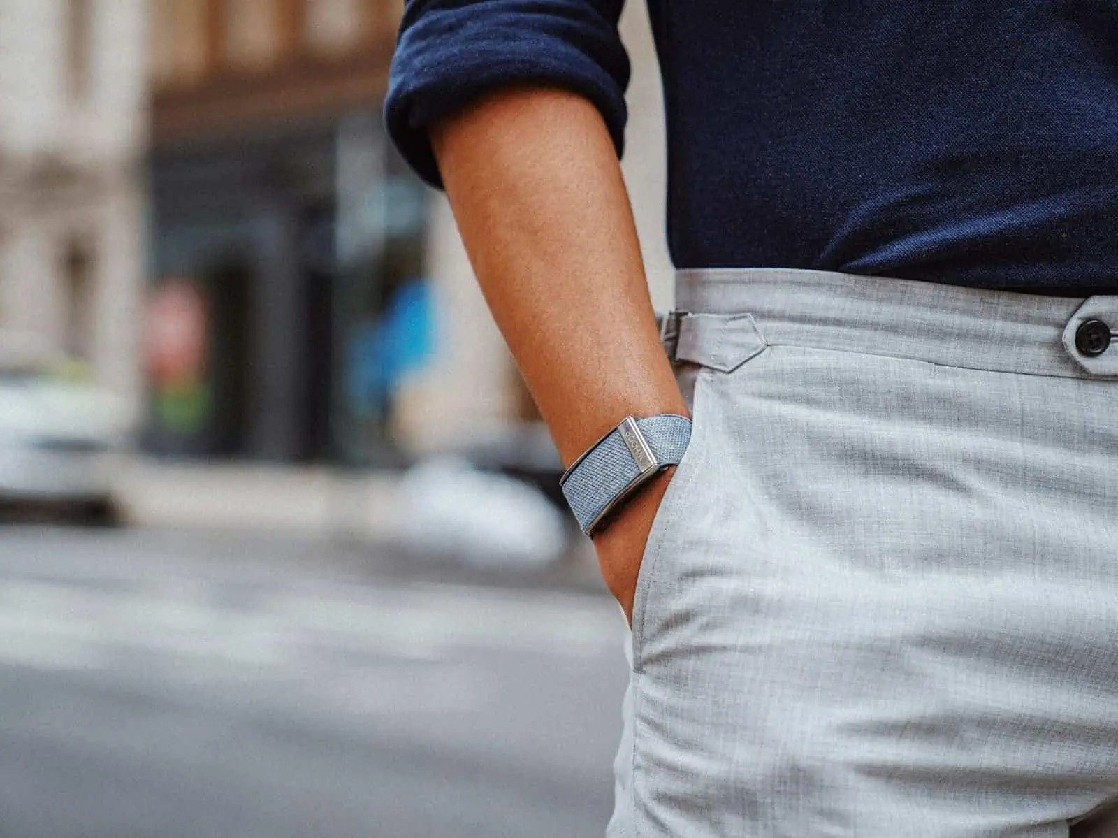 Men's casual business outfit with navy shirt and light gray trousers.