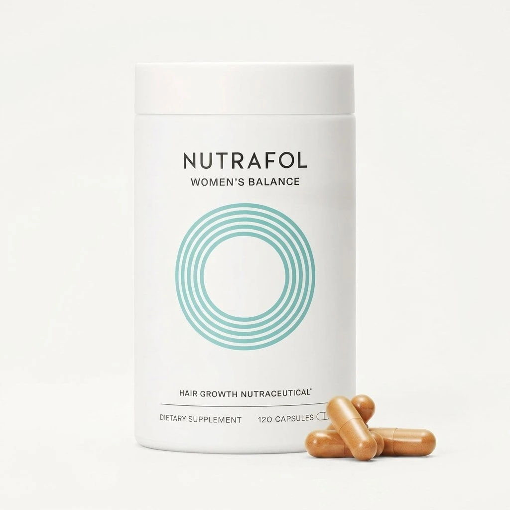 Nutrafol women’s hair growth supplement in a white bottle with capsules