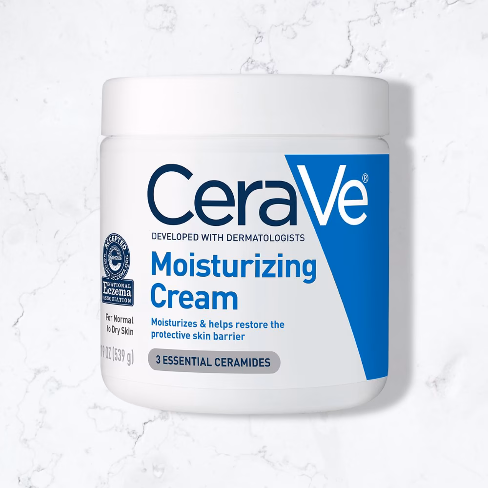CeraVe Moisturizing Cream, Body and Face Moisturizer for Dry Skin, Body Cream with Hyaluronic Acid and Ceramides, Daily Moisturizer, Oil-Free, Fragrance Free, Non-Comedogenic, 19 Ounce, product on a marble floor.
