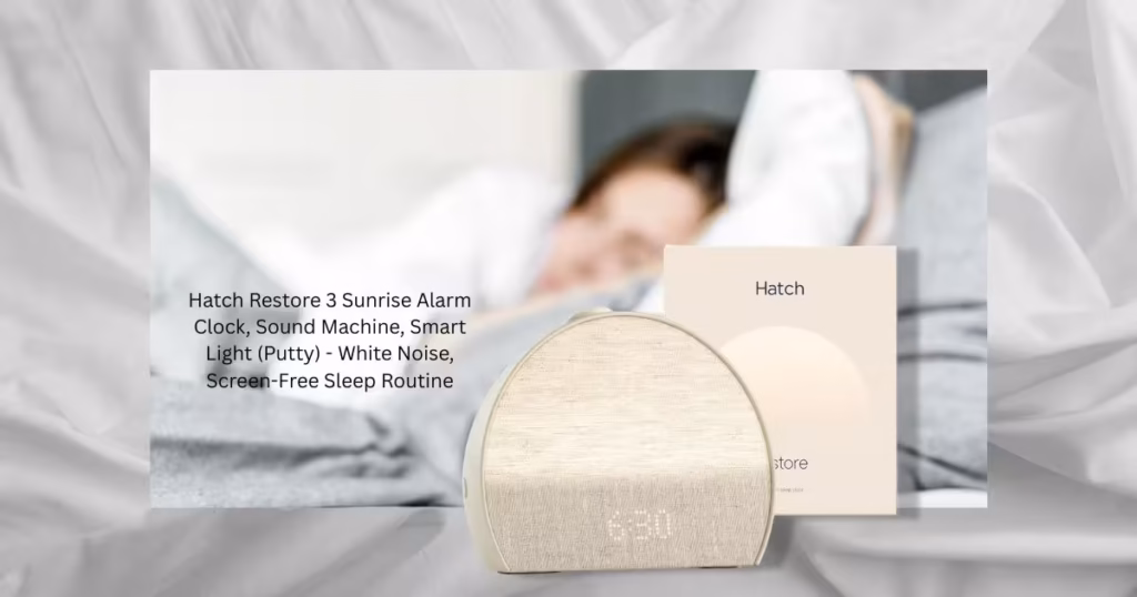 Hatch Restore 3 smart sunrise alarm clock sitting on a wooden bedroom nightstand with warm ambient lighting.