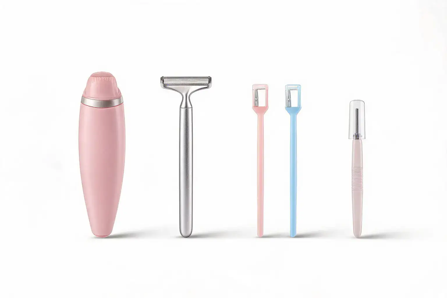 Dermaplaning tool formats compared in a row on white: a silver weighted metal dermaplaning razor, a pastel pink disposable face razor, a pastel blue disposable face razor and a slim precision eyebrow razor with a clear protective cover, beside a small pink tonic bottle